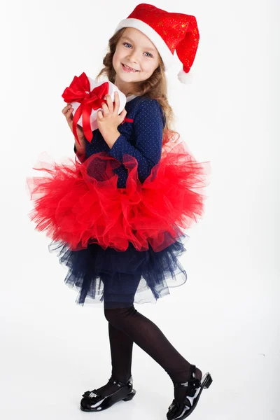 Happy child girl is holding red gift box — Stock Photo, Image