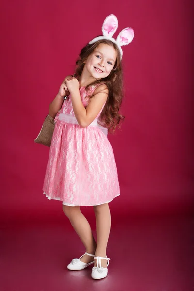 Child girl is wearing pink ears with gifts — Stock Photo, Image