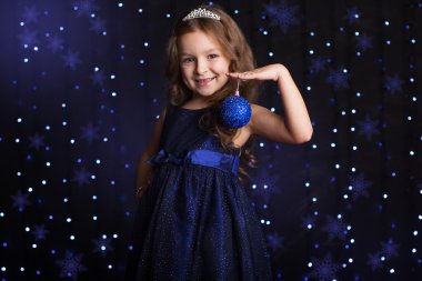 Pretty girl is holding Christmas tree toy