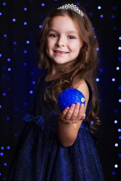 Happy girl with Christmas tree toy in a studio — Stock Photo, Image