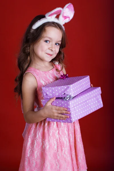 Bunny girl is holding gift boxes — Stock Photo, Image