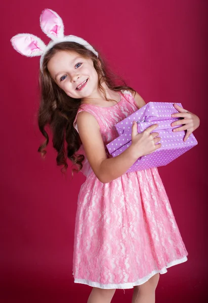 Happy bunny girl is holding gift boxes — Stock Photo, Image