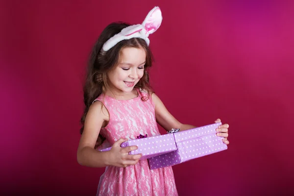 Girl is wearing pink dress and bunny ears — Stock Photo, Image