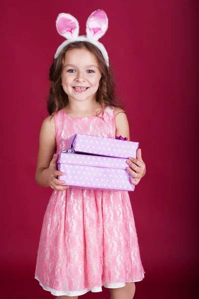 Happy child is wearing pink dress and bunny ears — Stock Photo, Image