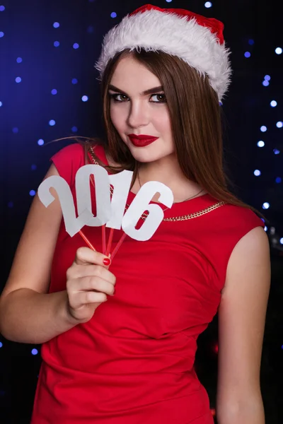 Santa girl is holding paper digits 2016 — Stock Photo, Image