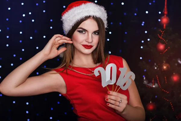 Girl is holding paper digits 2016, Christmas time — Φωτογραφία Αρχείου