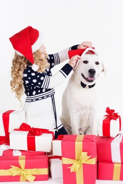 Girl and dog are sitting with christmas gifts — Stock Photo, Image