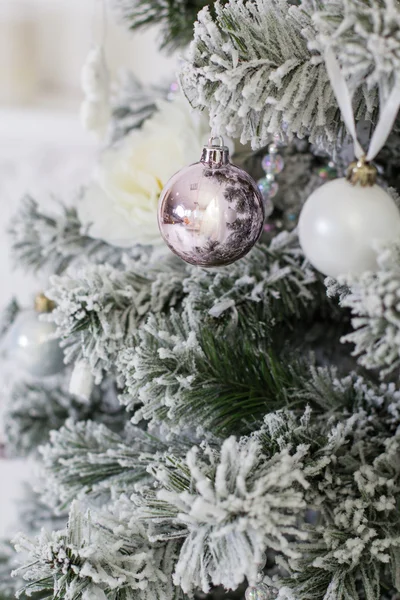 Snowy christmas tree with decorations — Stock Photo, Image