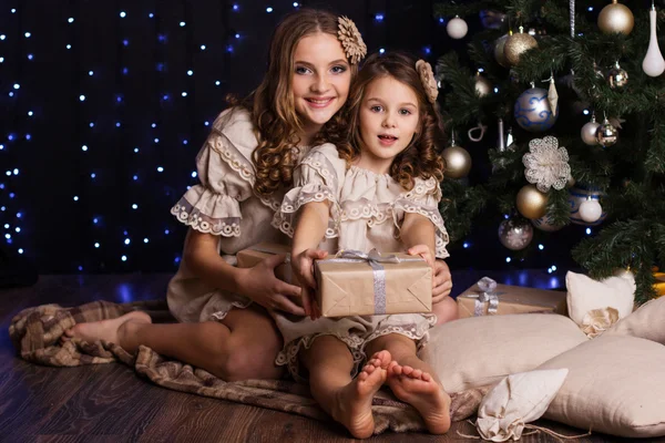 Две девочки с рождественскими подарками дома — стоковое фото