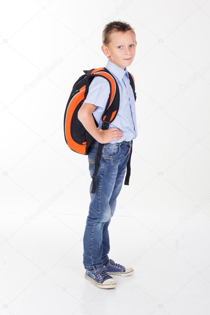 Serious school boy with bag isolated on white background