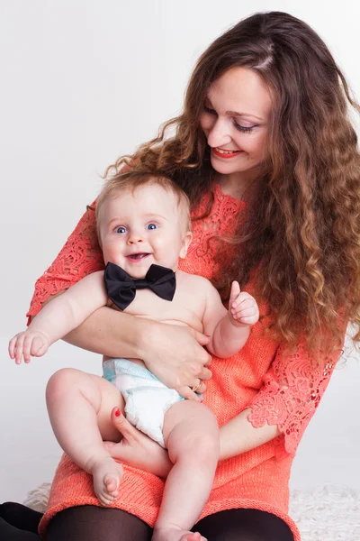Beautiful mother holding baby boy in studio — Stock Photo, Image