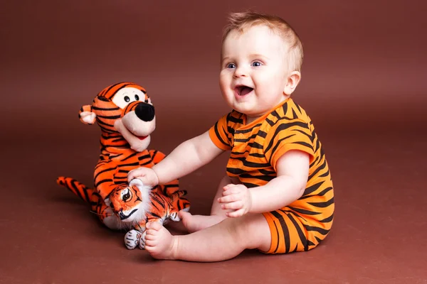 Baby boy with tiger toys — Stock Photo, Image