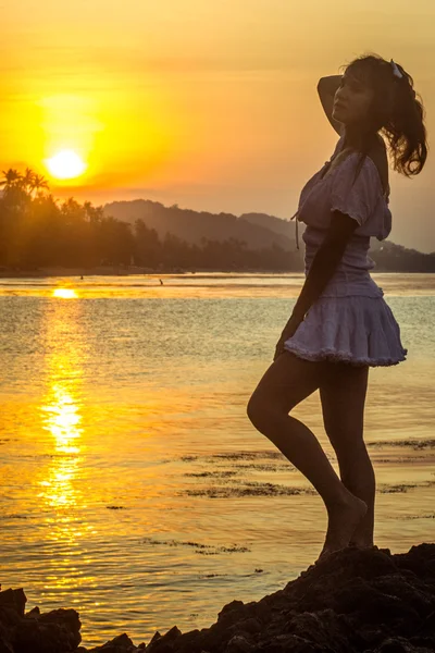 girl silhouette on sunset beach background