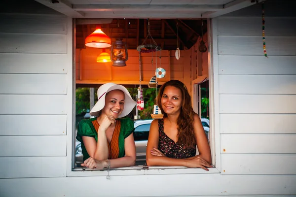 happy smiling women looking out of the window