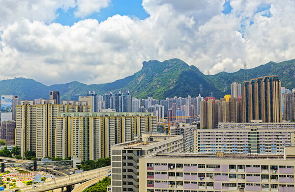 Hong Kong public estate buildings with landmark lion rock at day