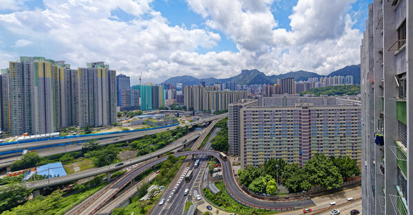 Hong Kong public estate buildings with landmark lion rock at day