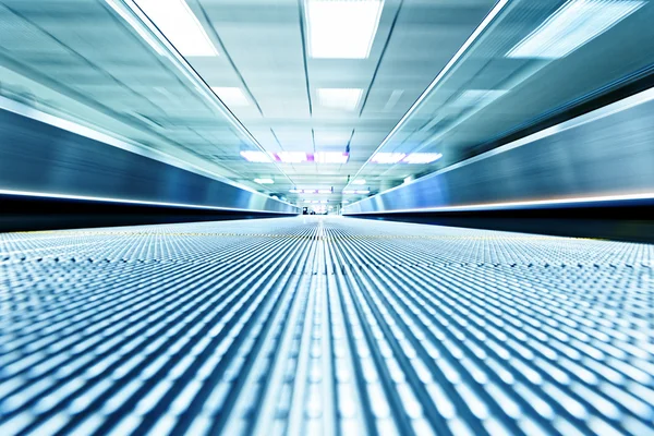 Symmetric moving blue escalator — Stock Photo, Image