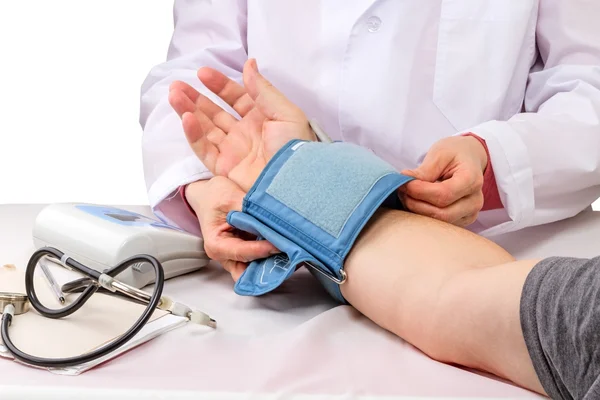 Doctor measures pressure to the patient — Stock Photo, Image