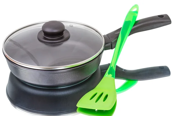 Pan with glass lid and spatula — Stock Photo, Image