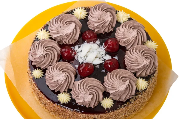 Cake with cream and cherries on a yellow plate — Stock Photo, Image