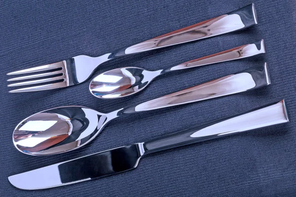 Eating utensils on a black fabric