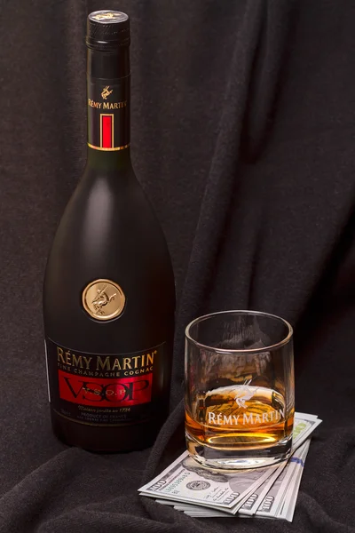 Cognac Remy Martin and US dollar banknotes — Stock Photo, Image