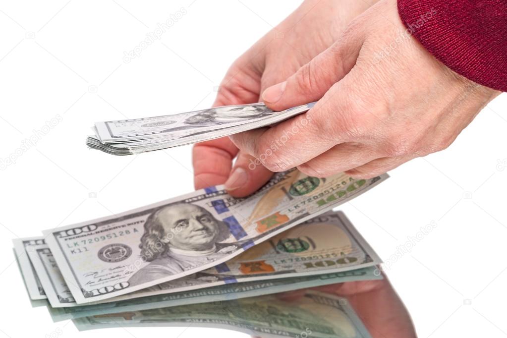 Hands and hundred dollar bills