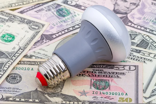 LED light bulb on dollar — Stock Photo, Image