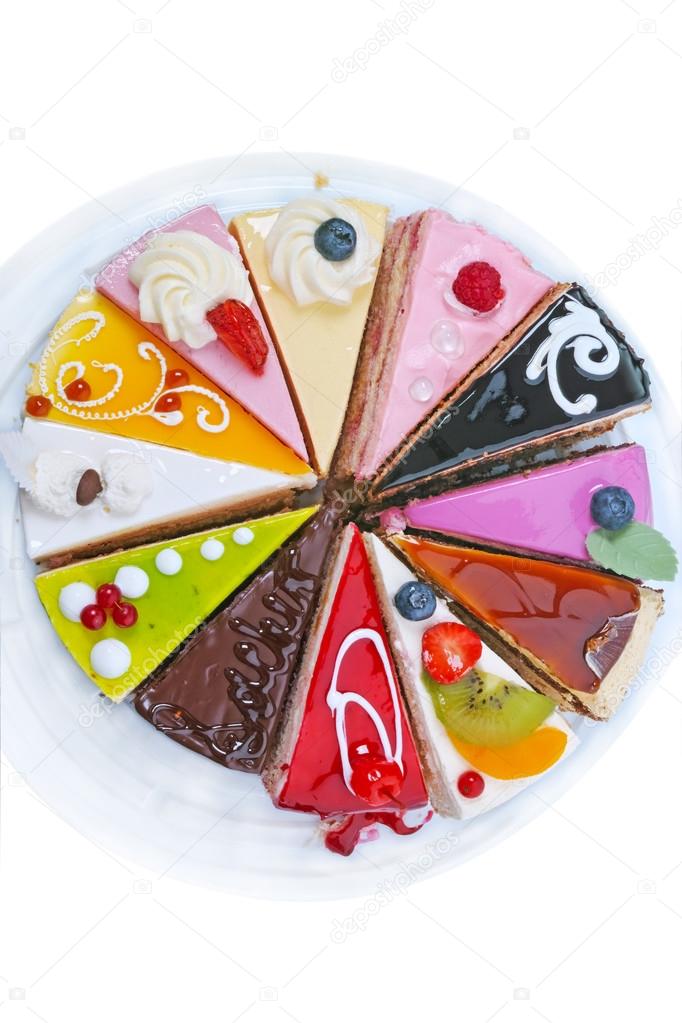 Different pieces of cake on white top view