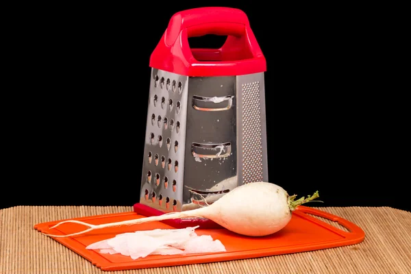 Pile of grated daikon and grater — Stock Photo, Image