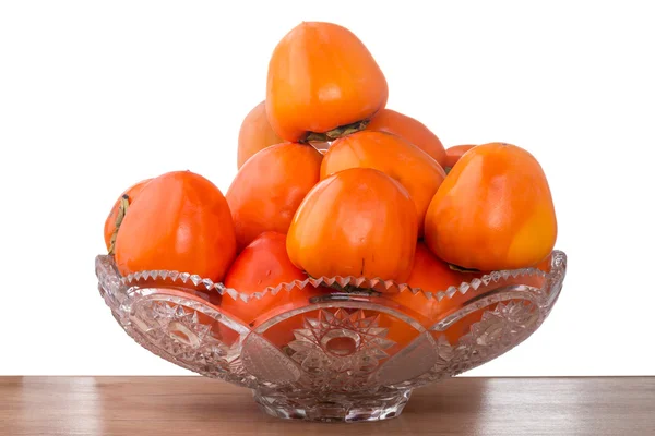 Persimmon in a glass vase — Stock Photo, Image