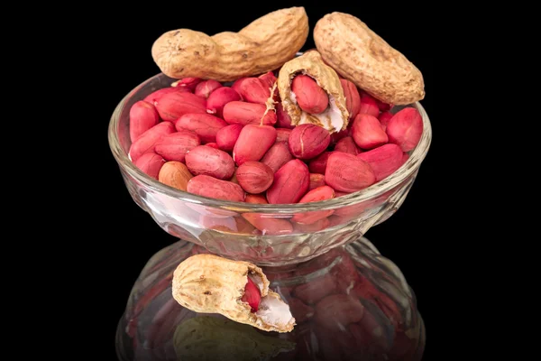 Peanuts in bowl on black — Stock Photo, Image