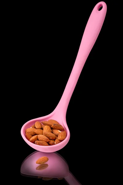 Almonds in a silicone spatula — Stock Photo, Image