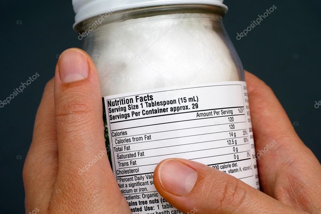 Reading a nutrition facts on coconut oil jar