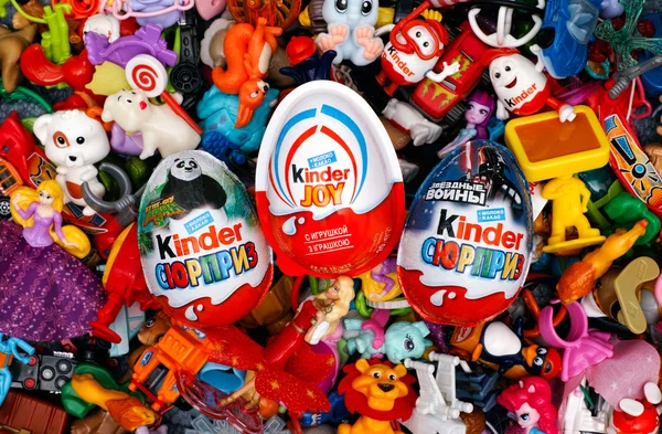 Big heap of Kinder Surprise toys and eggs. — Stock Photo, Image