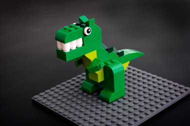 Lego green dinosaur toy on gray baseplate clipart