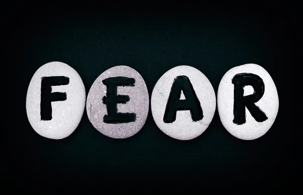 Word angst spell out van stenen met letters — Stockfoto