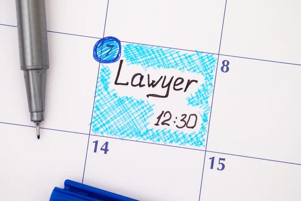 Reminder Lawyer in calendar with pen.
