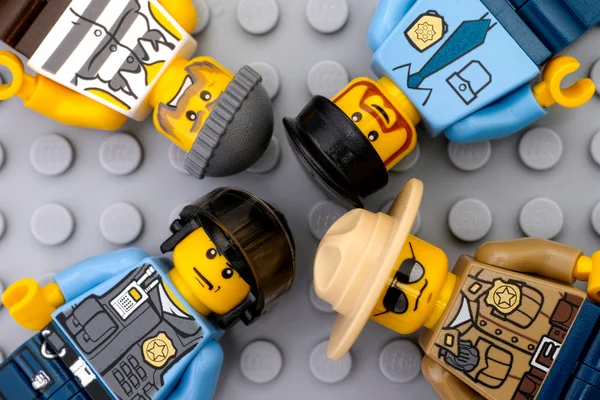 Трое полицейских Лего и одна криминальная минифигурка — стоковое фото