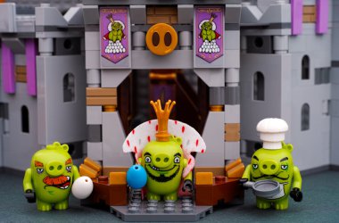 Lego King Pig, Chef Pig and Foreman Pig near Castle entrance clipart