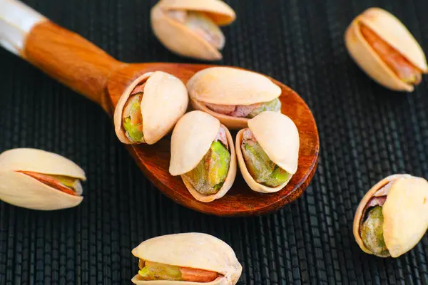 Pistachios Wooden Spoon Black Napkin Close — Stock Photo, Image