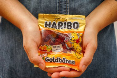 Tambov, Russian Federation - January 06, 2021 Woman palms with pack of Haribo Bears gummy candies. 
