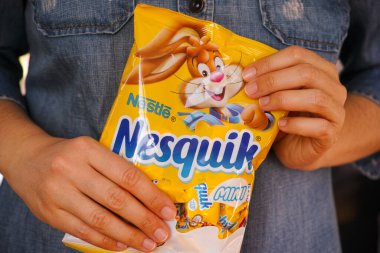 Tambov, Russian Federation - January 30, 2021 Nesquik candies pack by Nestle in woman hands.