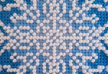 Beyaz boncuklu el yapımı mavi haç deseni. Tam çerçeve