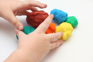 Child playing with playdough clipart