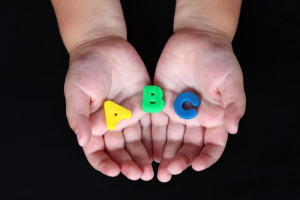 ABC em mãos de criança — Fotografia de Stock