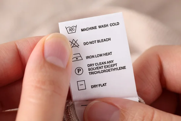 Clothes label with cleaning instructions — Stock Photo, Image