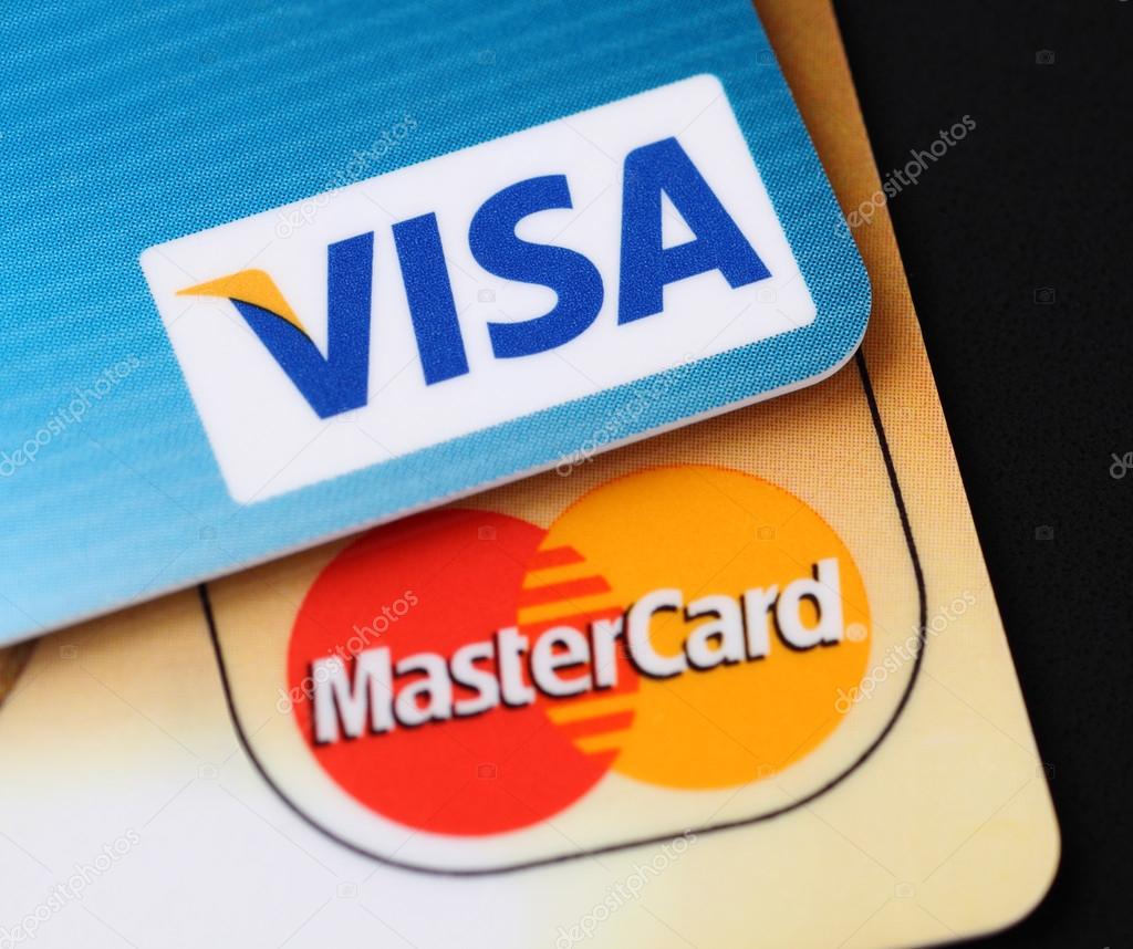 Tambov, Russian Federation - September 11, 2012 Visa and Mastercard logos on credit cards. Black background. Studio shot. Visa and Mastercard are a two biggest credit card companies in the world.