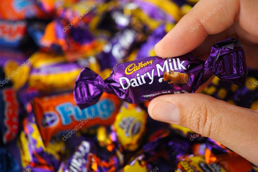 Cadbury Dairy Milk candy in womans hand Stock Editorial Photo