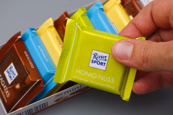 Ritter sport chocolate mini in woman hand — Stock Photo, Image